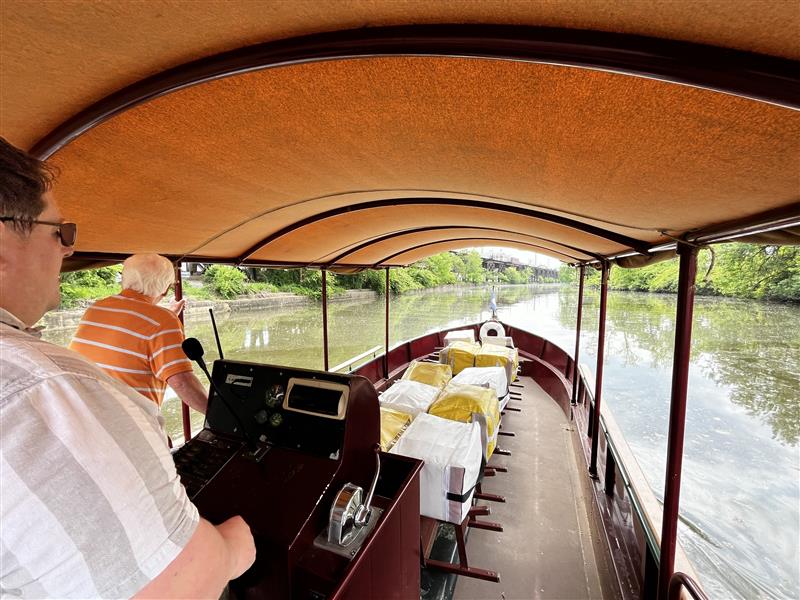 A graduate of Commonweath Autism's Career Readiness and Employment program for autistic adults pilots a canal boat along the James River in Richmond, Virginia.