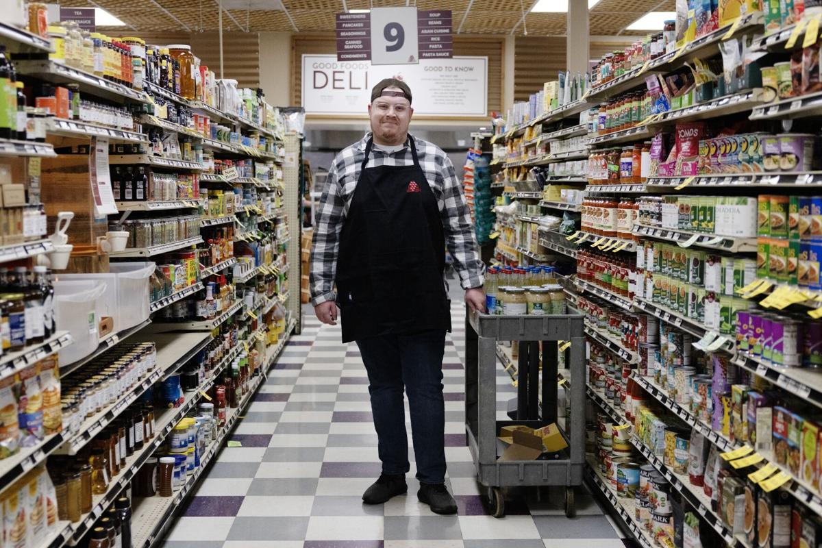 CA_GFG_CCO program A client in the Commonwealth Autism Career Readiness and Employment program stands in an aisle of Good Foods Grocery natural foods store in Richmond, Virginia.