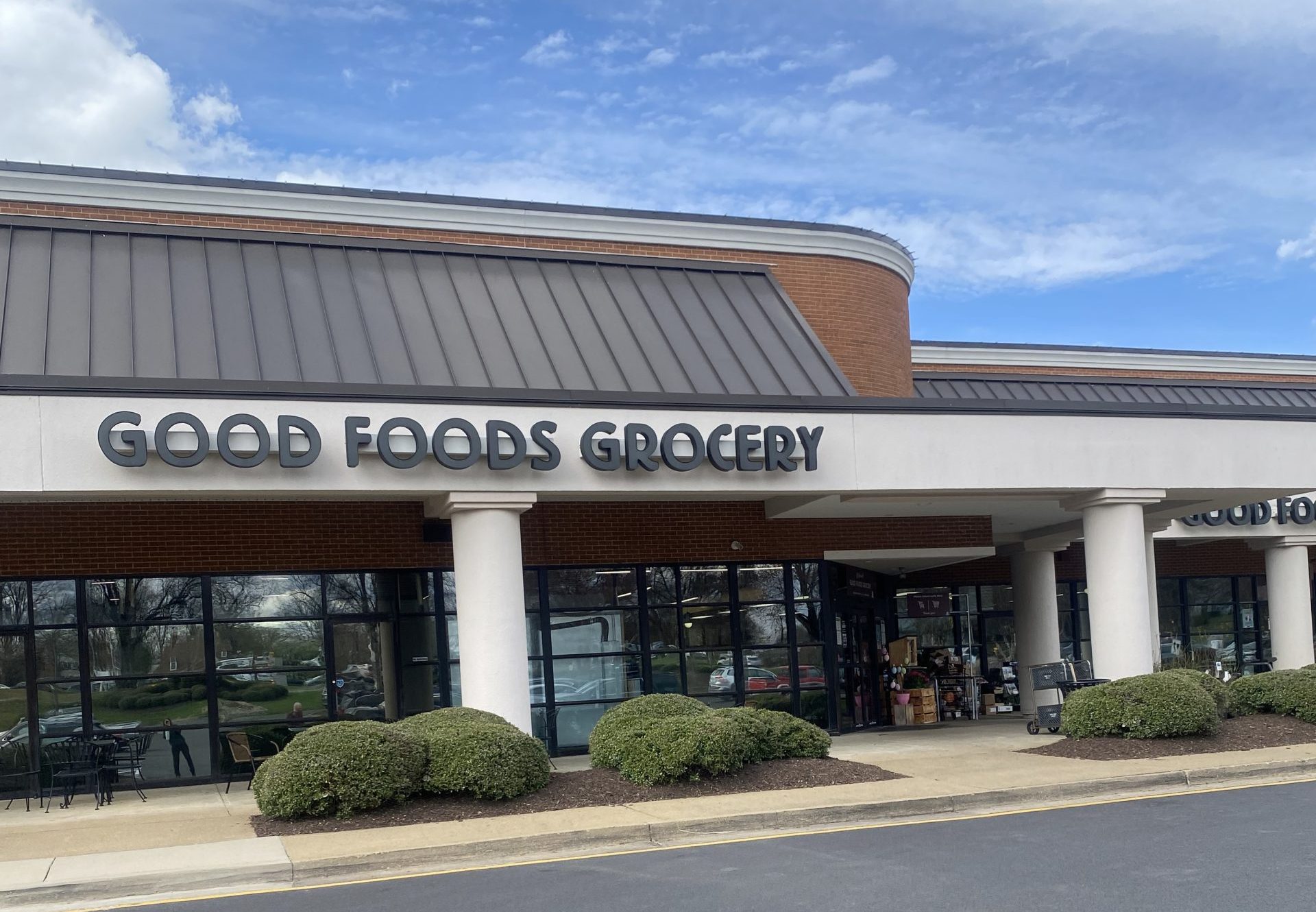good foods grocery storefront under blue sky